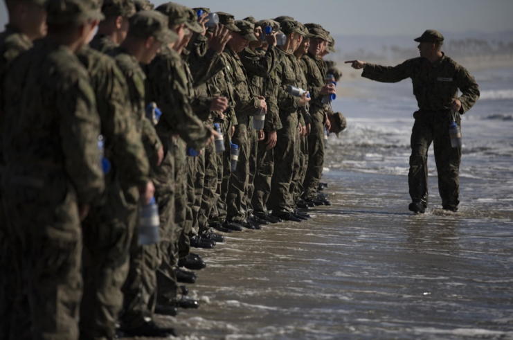 Navy SEAL trainees lined up on a beach