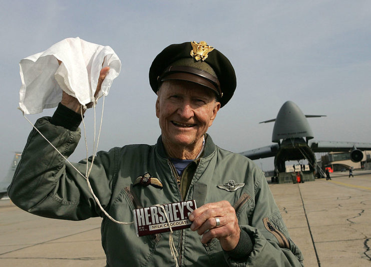 Gail Halvorsen holding a HERSHEY'S chocolate bar attached to a mini parachute