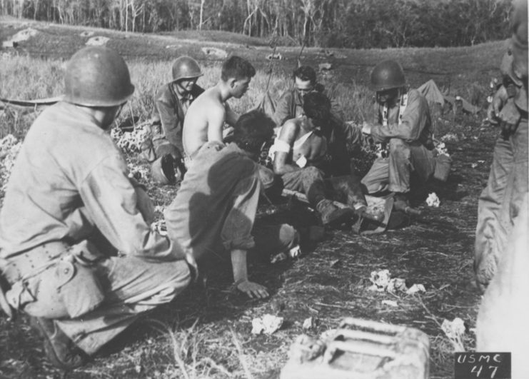 First aid being applied to an injured Marine