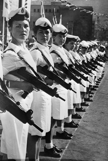 Israeli Female Marines lined up, holding Uzi submachine guns