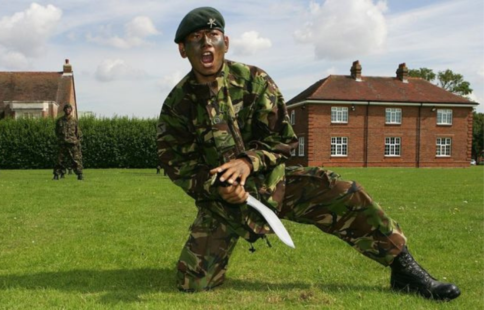 A Gurkha soldier brandishes a Kukri Knife