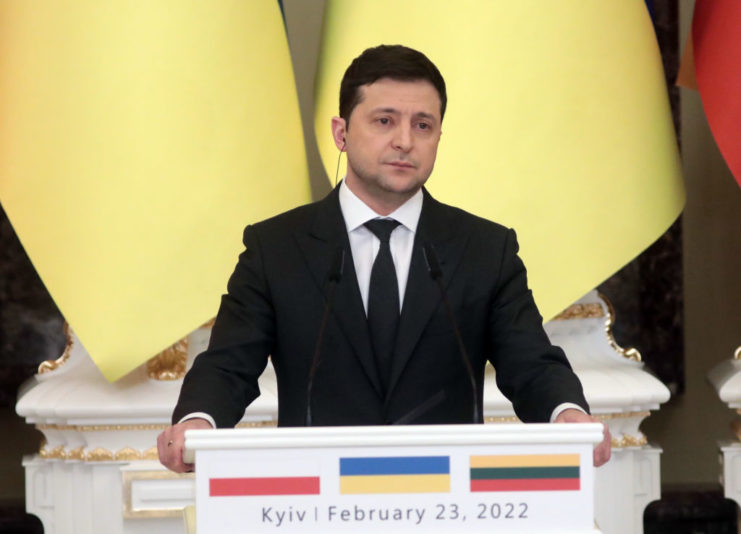 Volodymyr Zelenskyy standing at a podium
