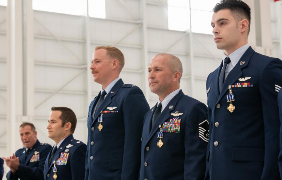 Lt. Col. Dominic Calderon, 1st Lt. Kyle Anderson, Master Sgt. Silva Foster and Senior Airman Michael Geller standing in uniform after receiving their Distinguished Flying Crosses