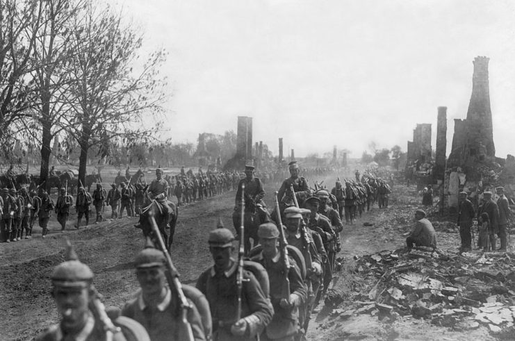 German troops march through the rubble of Puchaczow, Poland during the First World War