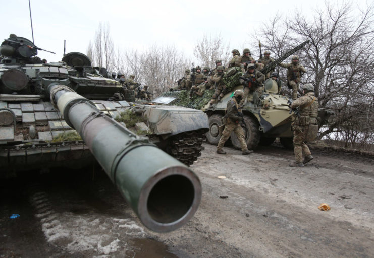 Ukrainian soldiers standing with tanks