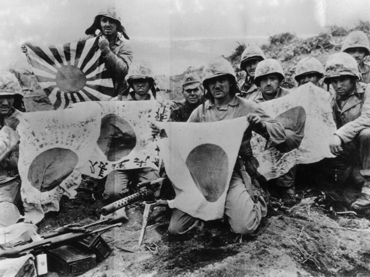 US Marines holding captured Japanese flags