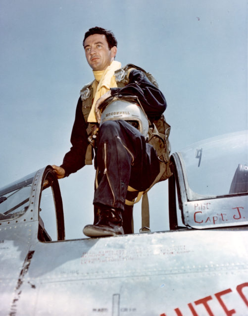 Joseph C. McConnell standing in the cockpit of his aircraft