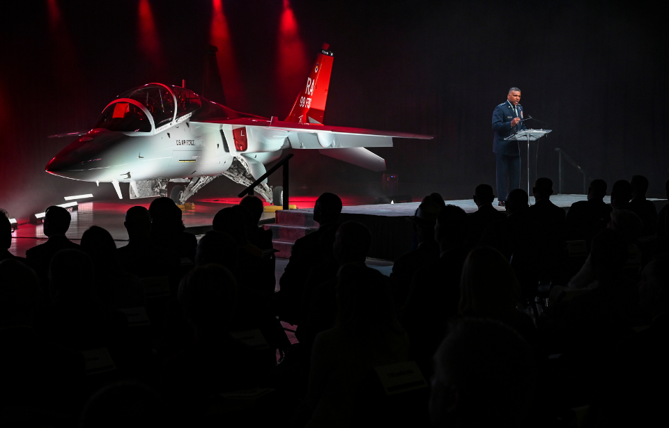 Lt. Gen. Richard Clark speaking in front of a Boeing-Saab T-7A Red Hawk