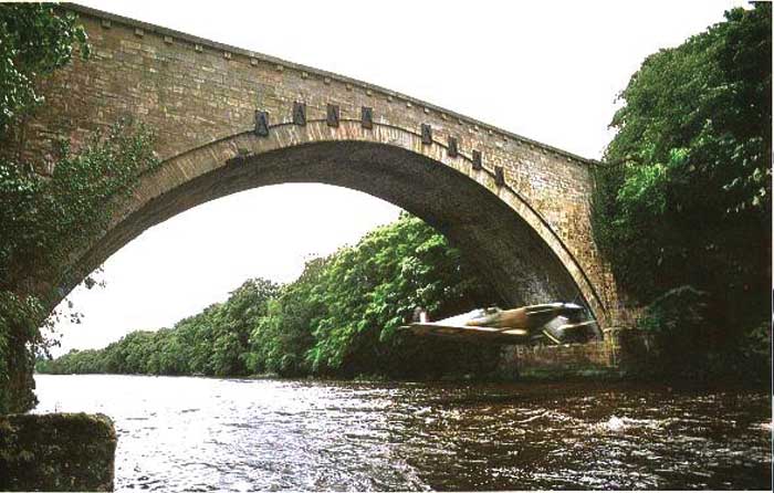 ay Hanna was an incredible pilot who flew in many movies including The Empire of the Sun and the TV series Piece of Cake. In this iconic image, Ray Hanna is seen flying under Winston Bridge, County Durham, for the filming of Piece of Cake.