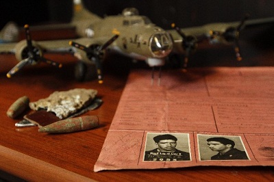 Francis displays is a replica of a B-17 plane, the kind his father flew during WWII, his father's war papers and plane fragments with bullets taken from the crash site.