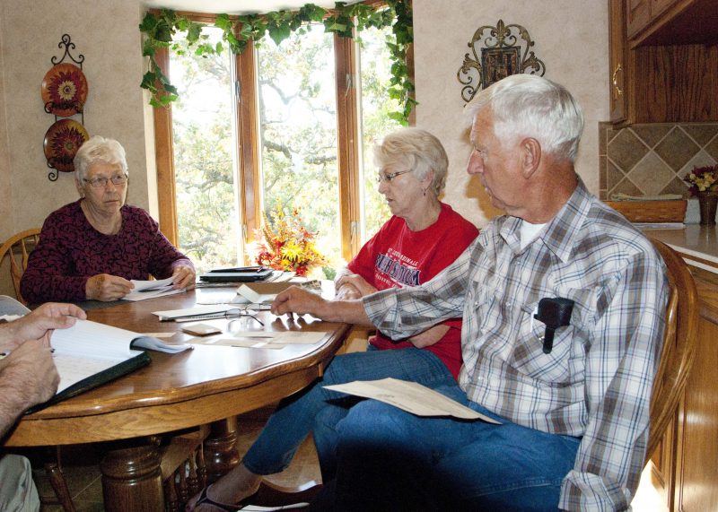 From left: Della Braun, Helen LePage, and Dave Van Loo discuss memories of their father, Emil Van Loo, who was a veteran of the First World War. They have pieced together much of his military service using newspaper articles and military records. Courtesy of Shawn C. Johnson