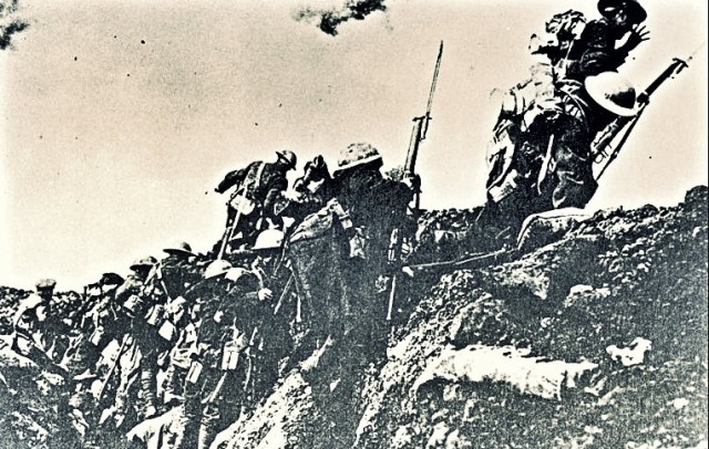 British soldiers climb out of the trenches during World War I.