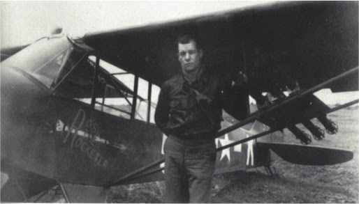 Lt. Col. Charles “Bazooka Charlie” Carpenter and his L-4 Grasshopper, mounting a trio of bazookas just outboard of the jury struts.