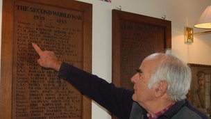 Tony Collett with the war memorial his father made for the village of Cotswolds.