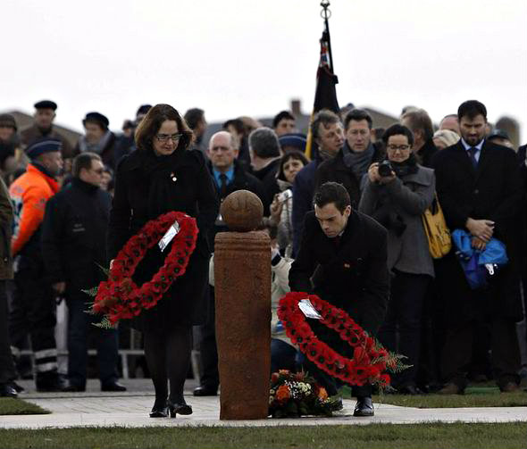 Laying of wreath on the Christmas Truce football monument by some dignitaries.