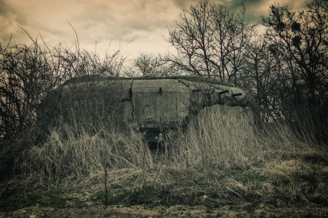 This ruined three-loophole machinegun pillbox still retaines its outer shape. But there's no layer of reinforced concrete thick enough to withstand a huge internal explosion. Dozens of artillery or mortal shells deliberately placed inside, sometimes coupled with dedicated explosive material, result in a detonation which wipes the interior clean. Fighting chambers and interior walls evaporate, floor collapses down into the storey below and the mighty structure breaks open.Hours and days of hard labor, sweat and cursing, hunger and fear – everything useless, everything forgotten, the whole world turned into rubble now cracklling under my feet.This is how empires collapse.