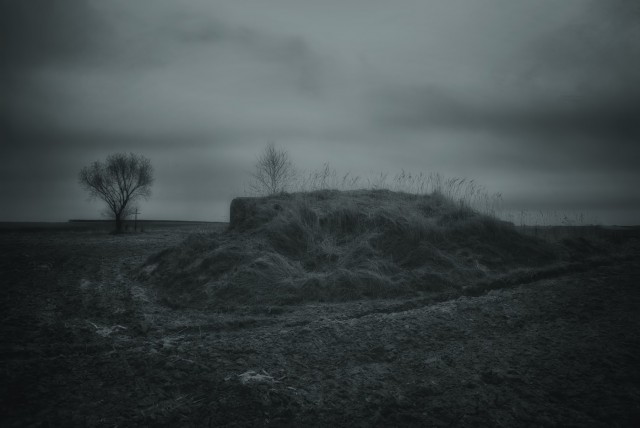 Still partially covered with its protective embankment, a single-chamber pillbox idles on an endless field - along with more than a dozen similar ones. They were supposed to screen the main defence line located several kilometers to the south-east, on the approaches to the Carpathian Mountains.Such simplified pillboxes, with no elaborate plumbing or air-exchange systems were supposed to fulfill an almost suicidal task - to give an early warning and force a deployment of the enemy, thus buying precious time for the main strongpoints to prepare for the onslaught.None of them has ever seen any combat, just as most of the key strongpoints they were supposed to screen.In 1941, when hell broke loose, the German advance was too swift and the defence, except for isolated pockets of resistance, never truly materialized.