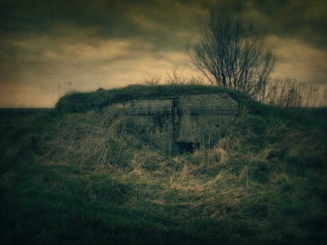 A simplified version of the smallest Molotov Line pillbox for one heavy machine gun. Even these simple form of fortification could prove to be a pain for the attackers. Well hidden under the protective embankment they are quite difficult to spot even today. Here just the entrance to the pillbox is barely visible, the single loophole is on the opposite side.Numerous pillboxes of this type screened the main defensive line in the south-eastern part of the Molotov Line but they were all abandoned by the Soviets and none took part in combat during the opening hours of the German advance into Soviet Union in 1941.