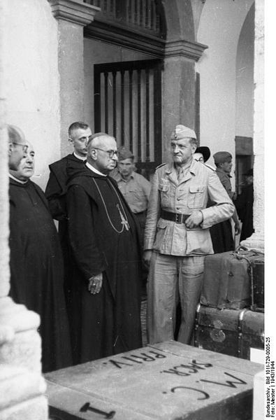 Abbot of Montecassino Abbey (left, with Pectoral Cross) supervises the packing of artworks from the Abbey about to be transferred to more secure places. The transfer was organized by the German Oberstleutnant (Lieutenant Colonel) Julius Schlegel (a roman catholic from Wien), Division "Hermann Göring" (right, in field uniform).