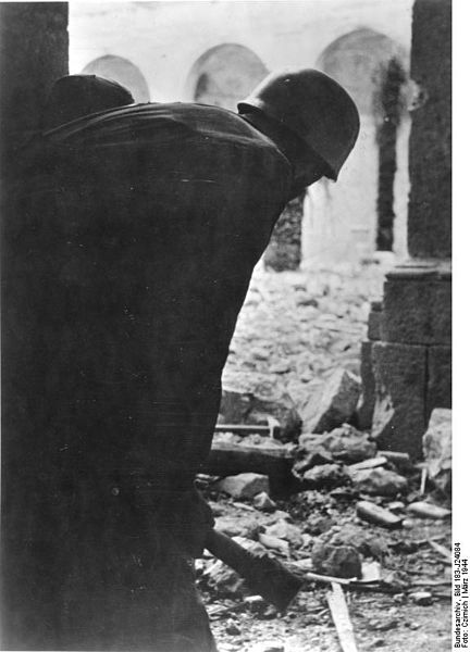 In the destroyed abbey a German soldier stands guard over nomansland.