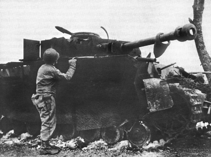 American_Soldier_Inspecting_Wrecked_German_Tank