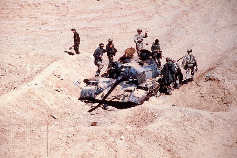 French and American soldiers inspecting an Iraqi Type 69 tank destroyed by the French 6th Light Armored Division during Operation Desert Storm.