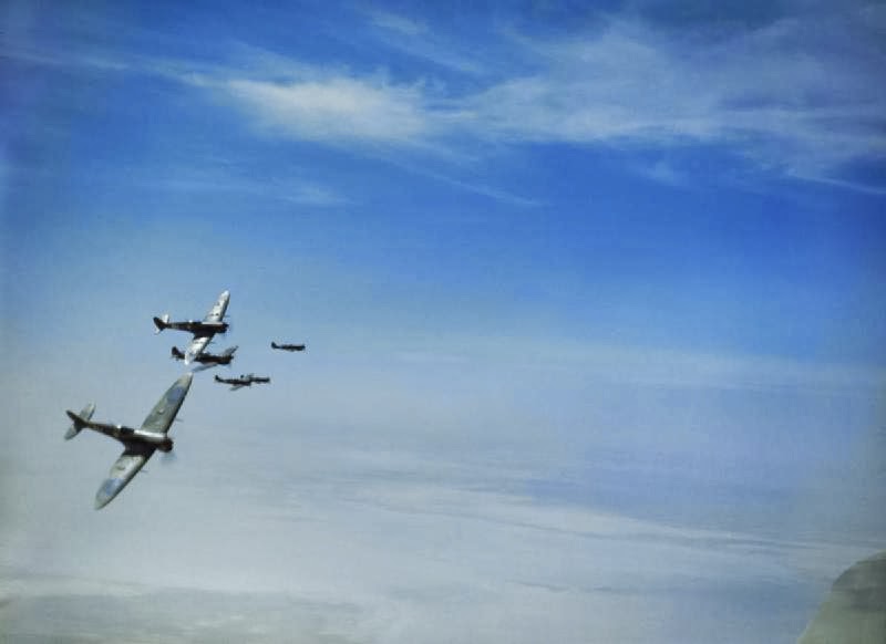 Supermarine Spitfire Mark Vs banking over Tunisia during a sortie to provide top cover for Allied bombers.