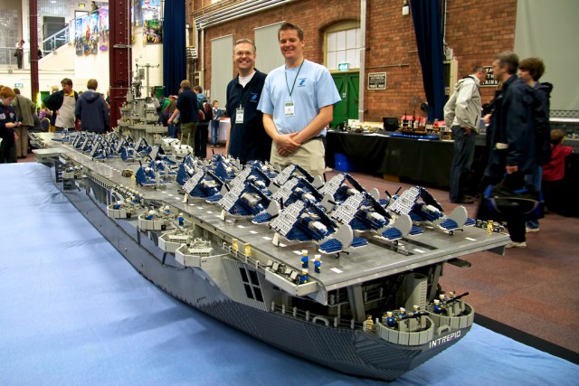 USS Intrepid (by Ann Diment, Ed Diment (right), Ralph Savelsberg (left)) USS Intrepid is a US Navy aircraft carrier that served from World War 2 until 1974 and is now a museum in New York.  This Lego model of the ship is to the scale of Minifigs (Lego people).  It is nearly 7m long, weighs 250kg, needed 250,000 bricks to build and took three people (with a number of other helpers) over 9 months to build