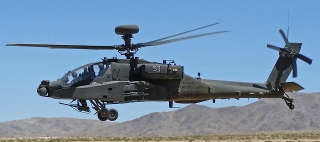 An AH-64E Apache from 1st Battalion, 25th Aviation Regiment, 25th Infantry Division, takes off from its landing pad after arming and refueling during the unit's rotation at the National Training Center on Fort Irwin, Calif., May 21.