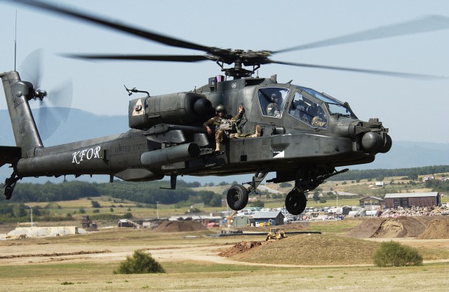 Capt. Sean Spence, the commander of B Co. TF Eagle, rides shotgun on an AH-64 Apache during an Apache extraction exercise Aug. 25 at Camp Bondsteel, Kosovo.