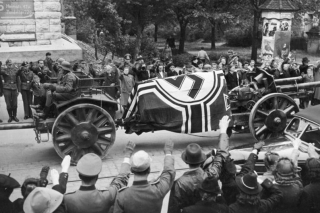 Die letzte Fahrt Marschall Rommels, In einer w¸rttembergischen Stadt nahm am Mittwoch Nachmittag das deutsche Volk in einem feierlichen Staatsakt Abschied von einem seiner bedeutendsten Heerf¸hrer dieses Krieges, Generalfeldmarschall Erwin Rommel, Tr‰ger der hˆchsten deutschen Tapferkeitsauszeichnung. Zahlreiche hohe Vertreter von Wehrmacht, Partei und Staat waren erschienen, um dem Verblichenen die letzte Ehre zu erweisen. Generalfeldmarschall von Rundstedt w¸rdigte in einer Gedenkrede die grossen Verdienste des toten Marschalls und legte im Auftage des F¸hrers einen Kranz an seinem Sarge nieder.- Unser Bild zeigt: In ehrf¸rchtigem Schweigen gr¸ssen die Zehntausende, die die Strassen s‰umen, den Sarg des toten Marschalls auf seiner letzten Fahrt. Scherl Bilderdienst (Hoffmann) 19.10.1944 ADN-Zentralbild/ Archiv II. Weltkrieg 1939-45 Staatsbegr‰bnis f¸r den am 14.10.1944 verstorbenen Generalfeldmarschall Erwin Rommel. Nach der Trauerfeier am 18.10. im Ulmer Rathaussaal wird der Sarg mit dem Verstorbenen, der wegen seiner Verbindung zu den Verschwˆrern vom 20. Juli zum Selbstmord gezwungen wurde, auf der Lafette zum Krematorium gefahren.