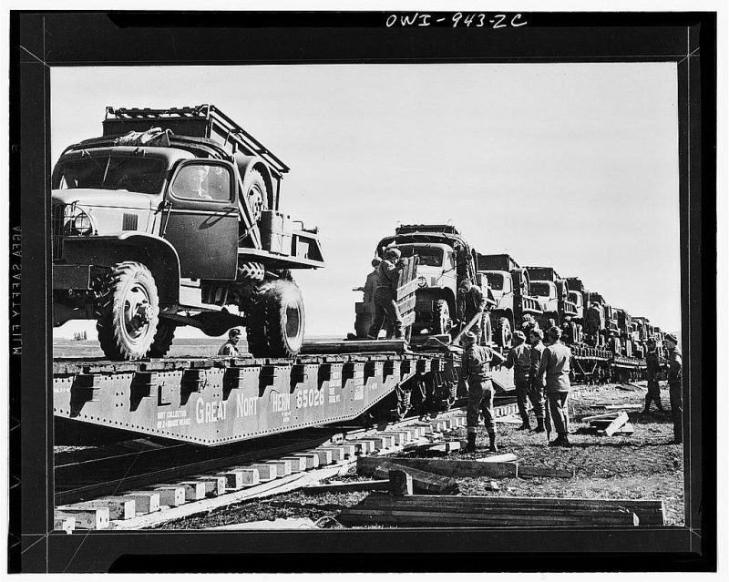 Alaska Highway Trukcs come in by flatcars