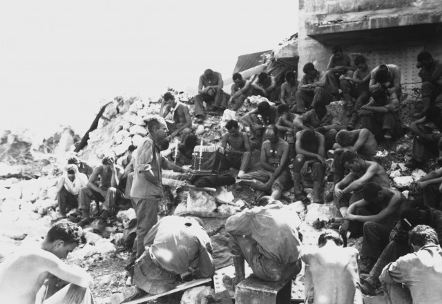 Protestant Chaplain Rufus W. Oakley holding services within a few hundred yards of Japanese positions, well within range of their mortars if they had chosen to throw them. Peleliu, September 1944. McElroy. (Marine Corps) Exact Date Shot Unknown NARA FILE #: 127-N-95743 WAR & CONFLICT #: 930