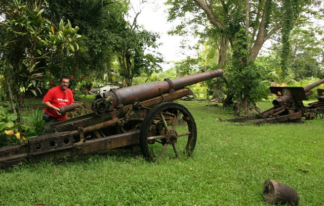  The author with abandoned Japanese heavy artillery at the village of Vilu, west of Honiara (RE)