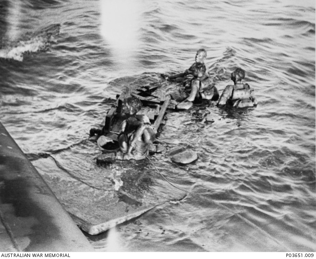 our Australians, survivors of the sinking of two Japanese prisoner of war transports, are rescued from the sea by crew members of the USN submarine USS Pampanito (SS-383). Covered in oil and clinging to a makeshift raft, they drifted in the sea for several days after USS Pampanito sunk the Kachidoki Maru on 12 September 1944. USS Sealion II (SS-315) had also sunk another transport Rakuyo Maru, carrying more prisoners of war, in the same attack that day. These four men would join additional Australian and British survivors rescued by other USN submarines which also joined in the search. After docking at Saipan on 25 September 1944, the overall group was later repatriated to Australia.