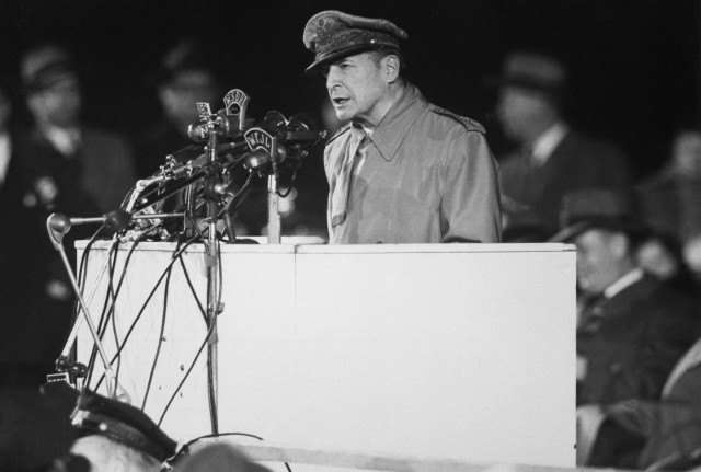 Gen. Douglas MacArthur addressing an audience of 50,000 at Soldier's Field, Chicago, on his first visit to the United States in 14 years, April 1951. Acme.
