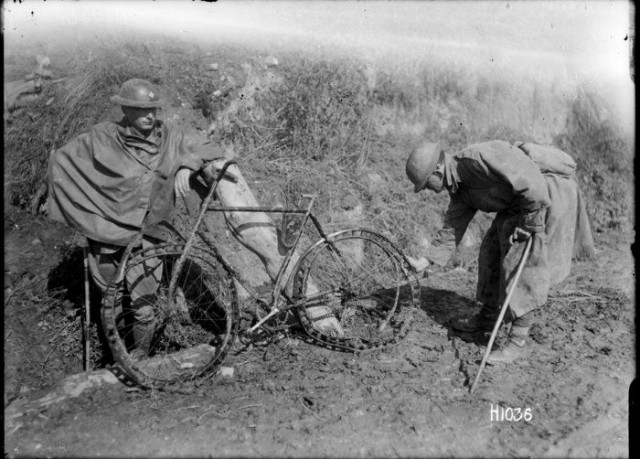 Soldiers inspecting a battered German bicycle with tyres made of springs due to the rubber shortage in World War I. Location probably France. Photograph taken 14 September by Henry Armytage Sanders.