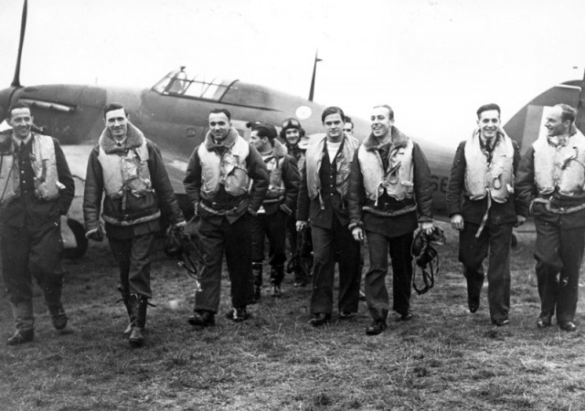 Pilots of 303 (Polish) Squadron walking away from a Hurricane.