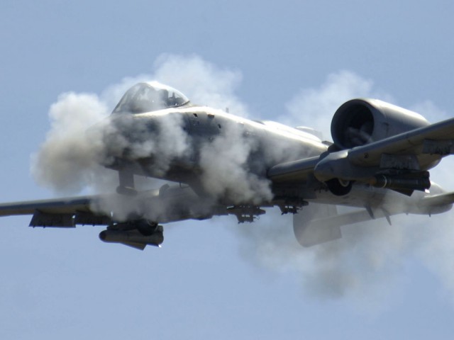 An A-10 Thunderbolt II, fires the 30 mm gun at a low angle strafe, as part of the 2006 Hawgsmoke competition, Thursday, March 23, 2006, at the Barry-Goldwater Range, Gila Bend Air Force Auxiliary Field. There are four parts of the competition. Each team has four members in which they have 100 bullets each to use toward the target. This year's competition coincides with the 30th anniversary of the Warthog. Twenty squadrons from around the world come together to gain the honor of the "best of the best" in ground attack and target destruction. (U.S. Air Force photo/Senior Airman Christina D. Ponte)