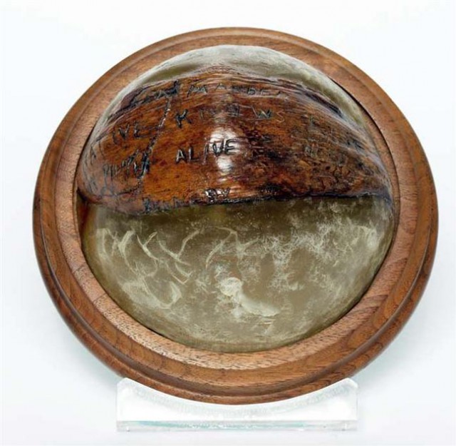 The coconut with the carved message, cast in a paperweight