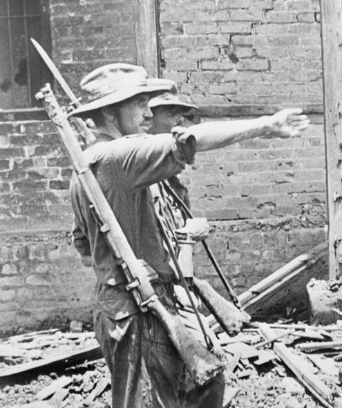 Lieutenant-Colonel James "Mad Mike" Michael Calvert giving orders after the capture of Mogaung in 1944
