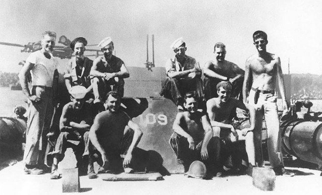 LTJG Kennedy (standing at right) on PT-109 in 1943