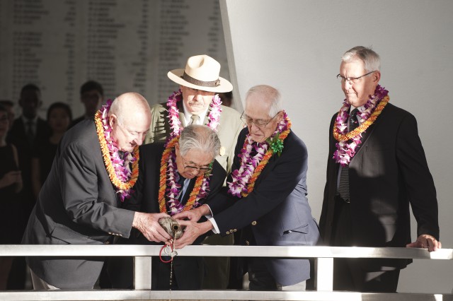 American and Japanese veterans pour bourbon whiskey into the hallowed waters of Pearl Harbor as a way to observe and celebrate the continued peace and reconciliation between the two nations during a Blackened Canteen ceremony as part of the Pearl Harbor Day – 74th Commemoration Anniversary Nov. 6, 2015, at the USS Arizona Memorial, Hawaii. The Blackened Canteen ceremony is a way for Americans and Japanese veterans and observers to extend a hand of continued friendship, peace and reconciliation by pouring bourbon whiskey as an offering to the fallen in the hallowed waters of Pearl Harbor. The ceremony is co-hosted by the National Park Service and Pacific Aviation Museum Pearl Harbor and is one event taking place leading up to the 74th anniversary of Pearl Harbor Day to pay tribute to the nation’s military while enlightening Americans about veterans and service. (U.S. Air Force photo by Staff Sgt. Christopher Hubenthal)