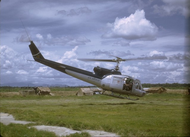 Air America Huey taking off from MACV Team outpost in Chau Doc Province, An Phu District in 1969, about 1 km from the Cambodian border. 