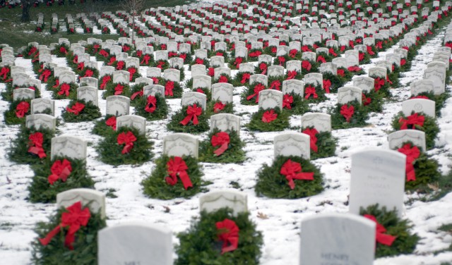 ARLINGTON, Va. (AFPN) -- Christmas wreaths adorn head stones at Arlington National Cemetery. The 14th annual wreath laying event is the result of Worcester Wreath Company's owner Morrill Worcester's, childhood dream of doing something to honor those laid to rest in the national cemetery. More than 5,000 donated wreaths were placed by volunteers this year. (U.S. Air Force photo by Master Sgt. Jim Varhegyi)