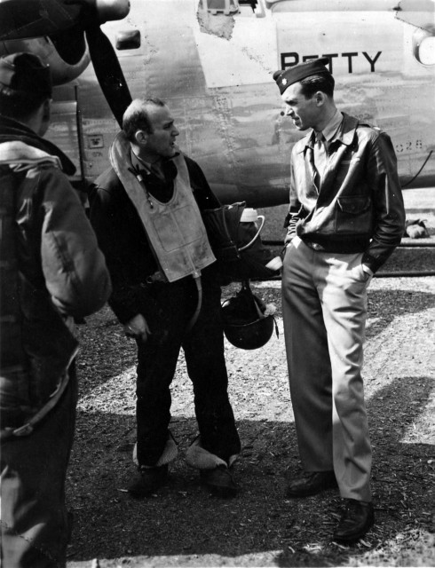 Maj. Jimmy Stewart confers with a B-24 crew member.