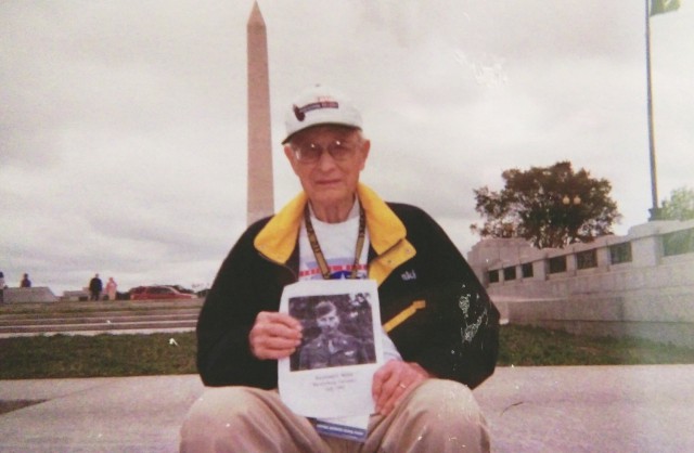 While visiting Washington, D.C., as part of the Central Missouri Honor Flight in 2012, Jefferson City, Mo., veteran Robert Miller posed for pictures with a photograph of his brother, Raymond, a Battle of the Bulge veteran who died in 2007.Courtesy of Robert Miller