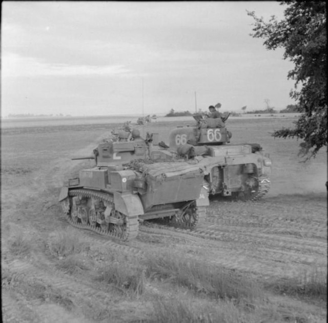 A Stuart and Sherman tanks of 33rd Armoured Brigade during Operation 'Charnwood', the attack on Caen, 8 July 1944.