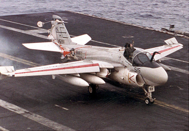 LT Keith Gallagher is seen above the canopy as the A-6 aircraft touches down on the deck of the Lincoln. Note that LT Gallagher's parachute has deployed and is wrapped around the tail of the aircraft. (Navy photo) 