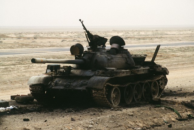 The charred remains of an Iraqi T-55 main battle tank sits on the Iraqi-Kuwait border, destroyed by Coalition armor heading into Kuwait during Operation Desert Storm.